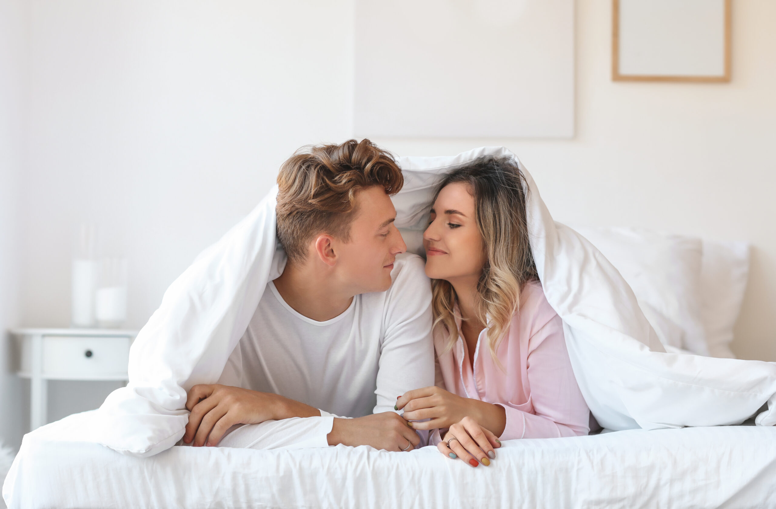 A couple in bed together, under the covers